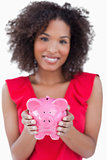Piggy bank being held by a brunette woman
