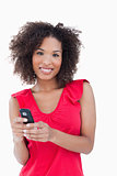 Smiling young woman holding her mobile phone