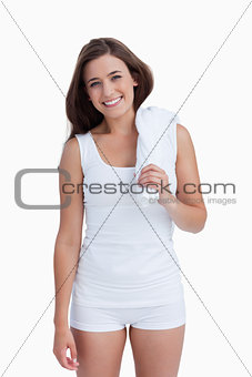 Smiling woman holding a white towel on her shoulder