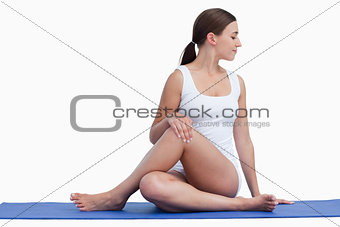 Young woman making exercises on her yoga mat