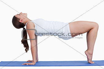 Young woman practicing yoga on a mat