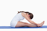 Young woman sitting on a yoga mat