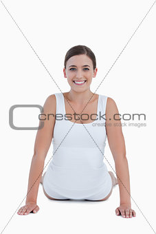 Smiling woman looking at the camera while doing exercises