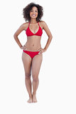 Smiling woman standing upright in swimsuit
