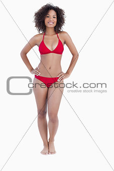 Smiling woman standing upright in swimsuit
