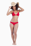 Young brunette woman standing upright in swimsuit