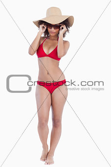 Attractive young woman in beachwear standing upright