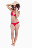 Attractive young woman standing upright in swimsuit