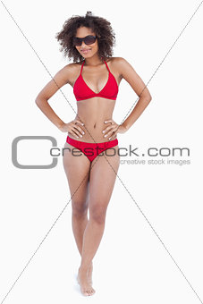 Attractive brunette standing upright in swimsuit
