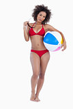Attractive woman holding her sunglasses and a beach ball