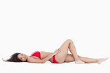 Attractive woman lying down while looking at the camera