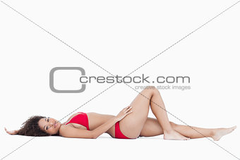 Attractive woman lying down while looking at the camera