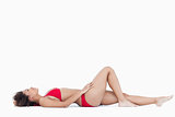 Attractive woman in swimsuit lying down