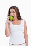Smiling woman eating a green apple