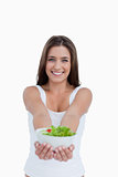 Smiling young woman holding a salad