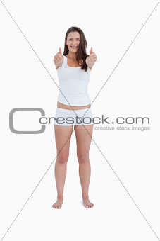 Happy woman placing her thumbs up