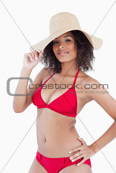 Beautiful young woman looking at the camera while standing with 