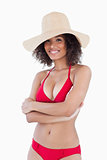 Smiling woman standing in swimsuit with arms crossed