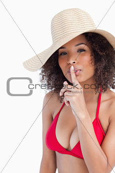 Attractive young woman asking for silence