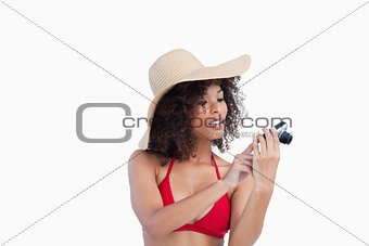 Attractive woman looking at her digital camera