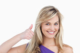 Smiling blonde woman placing her thumbs up