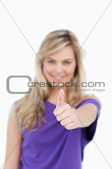Thumbs up being placed by a blonde woman