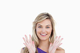 Smiling woman showing her surprise with hands raised