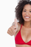 Thumbs up being placed by an attractive brunette woman