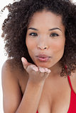 Attractive brunette woman sending an air kiss