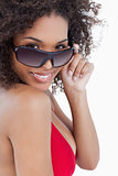 Smiling woman looking over her sunglasses
