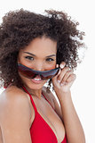 Smiling young woman looking over her sunglasses