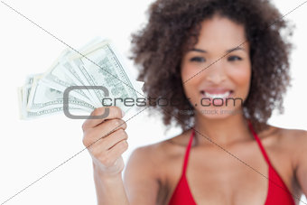 Bank notes being held by an attractive woman
