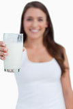 Glass of milk being held by a young woman