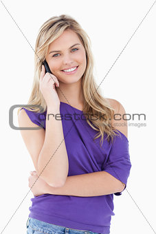 Happy blonde woman using her cellphone