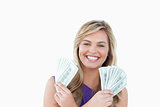 Happy blonde woman holding dollar notes