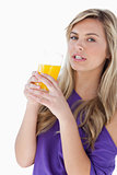 Attractive blonde woman holding an orange juice