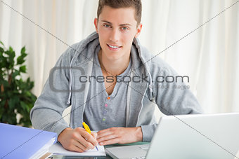 Portrait of a student doing his homework