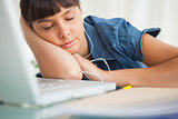 Tired female student enjoying music