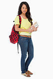 Beautiful Latin student with backpack holding textbooks