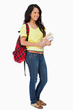 Smiling Latin student with backpack holding textbooks