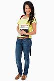 Portrait of a beautiful Latin student with backpack holding text