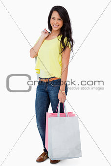 Smiling Latin student with shopping bags