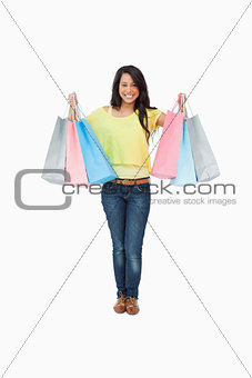 Beaming Latin student with shopping bags
