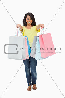 Pretty Latin student showing her shopping bags