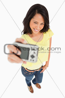 Pretty young woman taking a picture of herself