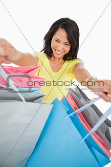 High-angle view of a young woman showing shopping bags