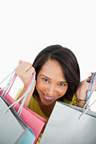 Close-up of a young woman showing shopping bags