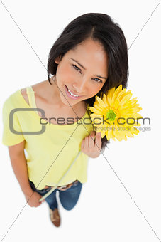 High-angle view of a Latino woman holding a flower