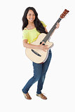 Young Latino woman holding a guitar