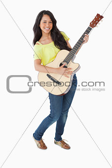 Young Latino woman holding a guitar